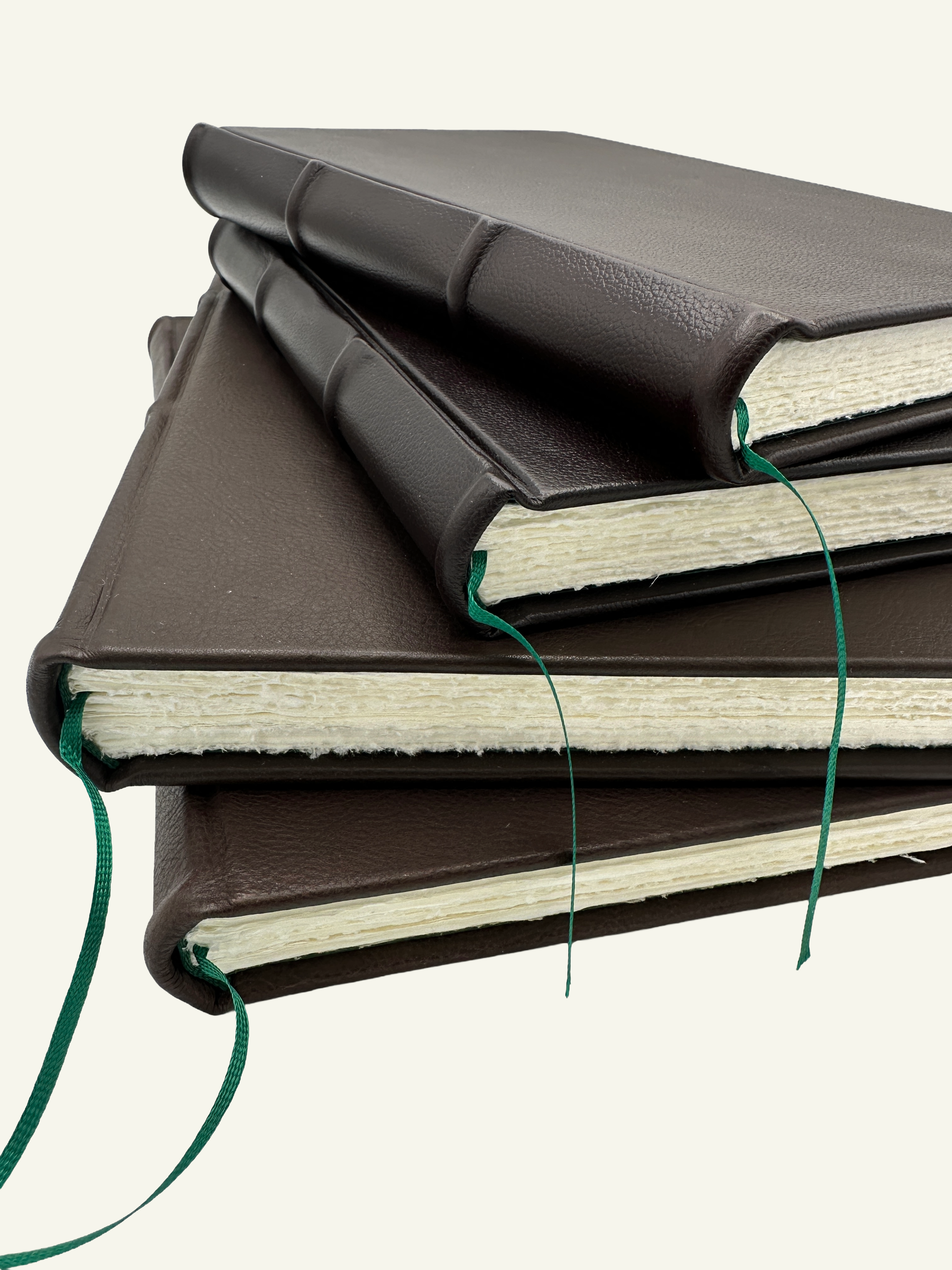Handmade Italian leather journals and guestbooks with textured Amalfi paper pages and a green ribbon bookmark