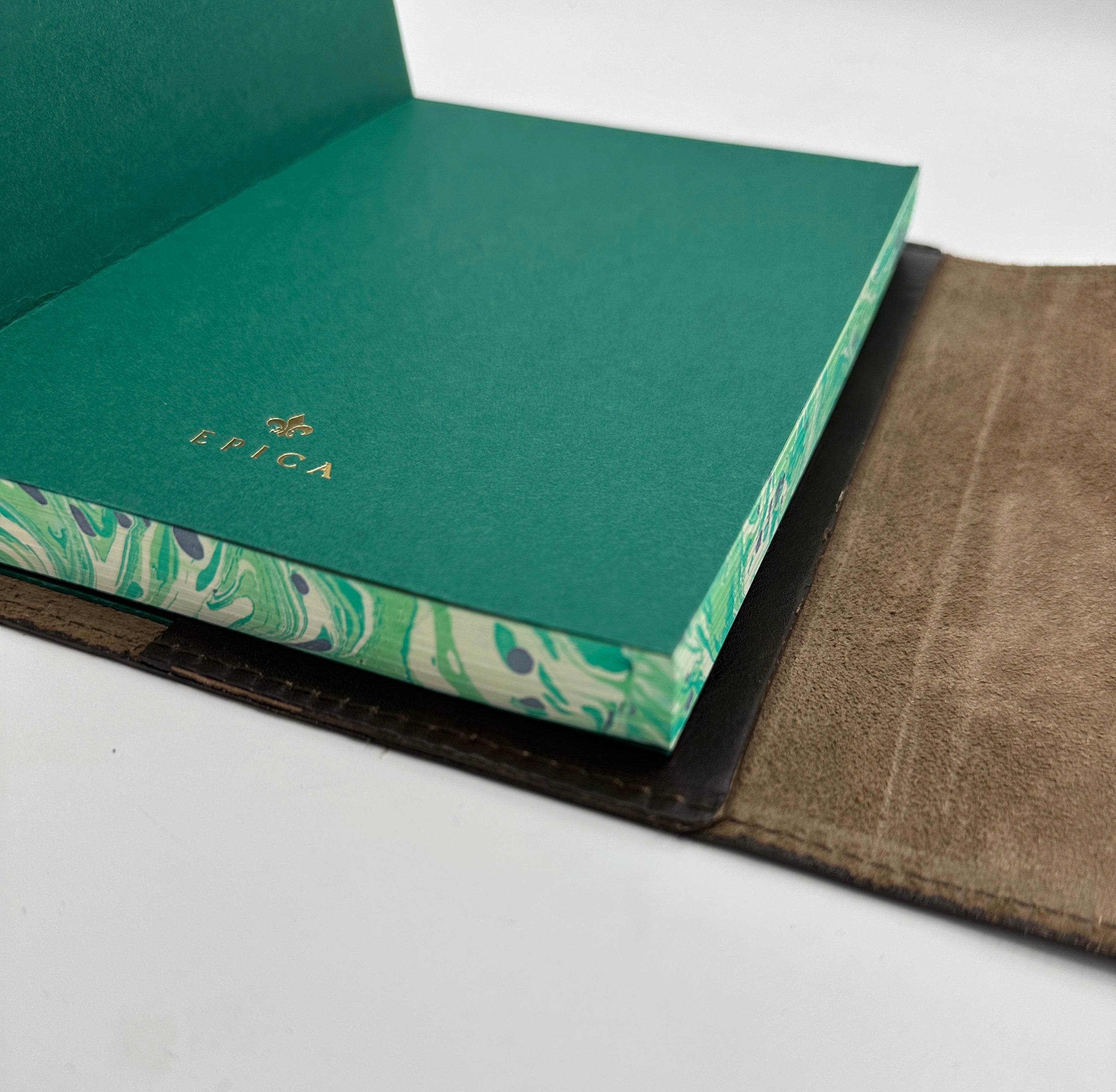 Refillable wrap style leather journal with green and ivory marbled edges