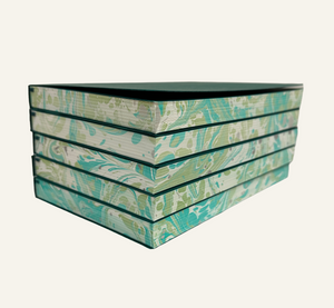 Marbleized edges of green and ivory refillable journal inserts