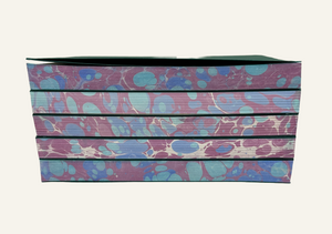 Marbleized stack of refillable journal inserts is blue and burgundy