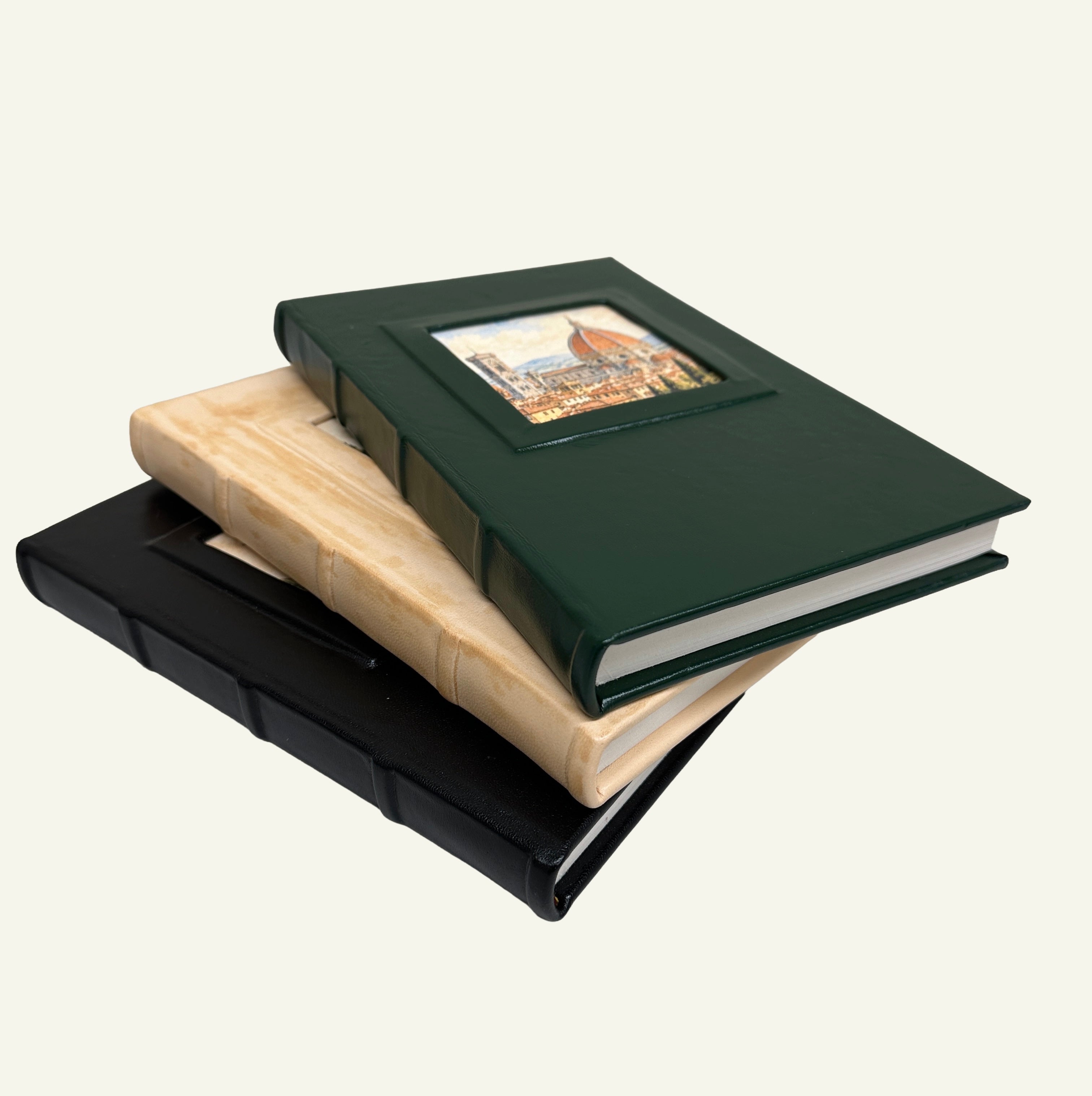 Close-up of the square spine and raised portrait window detail on a forest green leather journal.