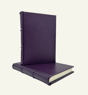 Handmade Italian violet leather journal with lined pages and rounded spine