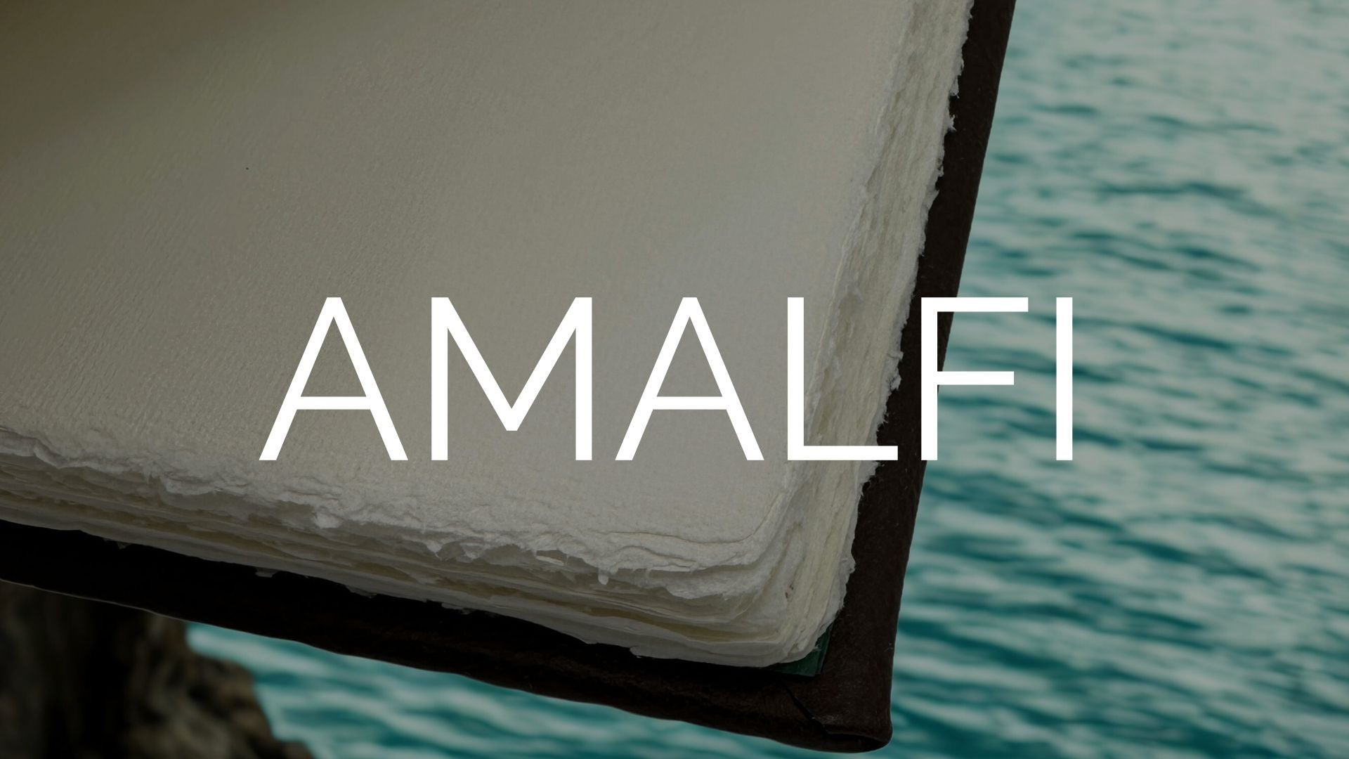 Artisan lifting handmade Amalfi paper sheet from vat in Valle dei Mulini, Italy