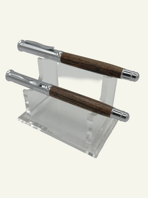 Two luxury Italian wood rollerball pens with the cap on showcasing the polished chrome hardware and natural wood finish.