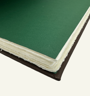 Handcrafted Amalfi journals and guestbooks featuring Epica’s signature green flyleaf and matching endpapers