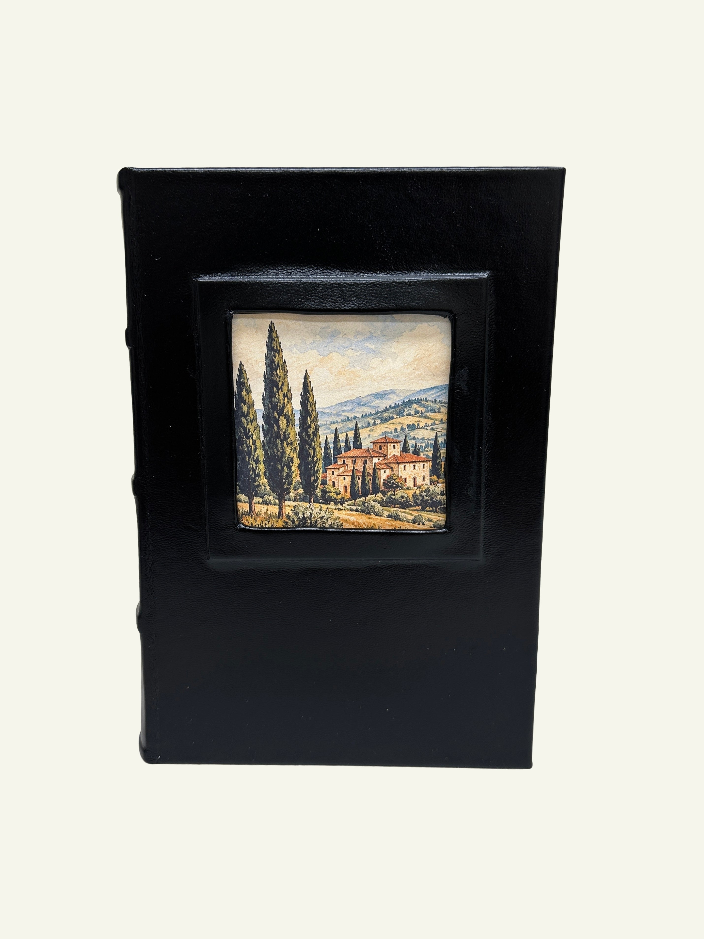 Black leather journal featuring a Tuscan village landscape in the front portrait window.