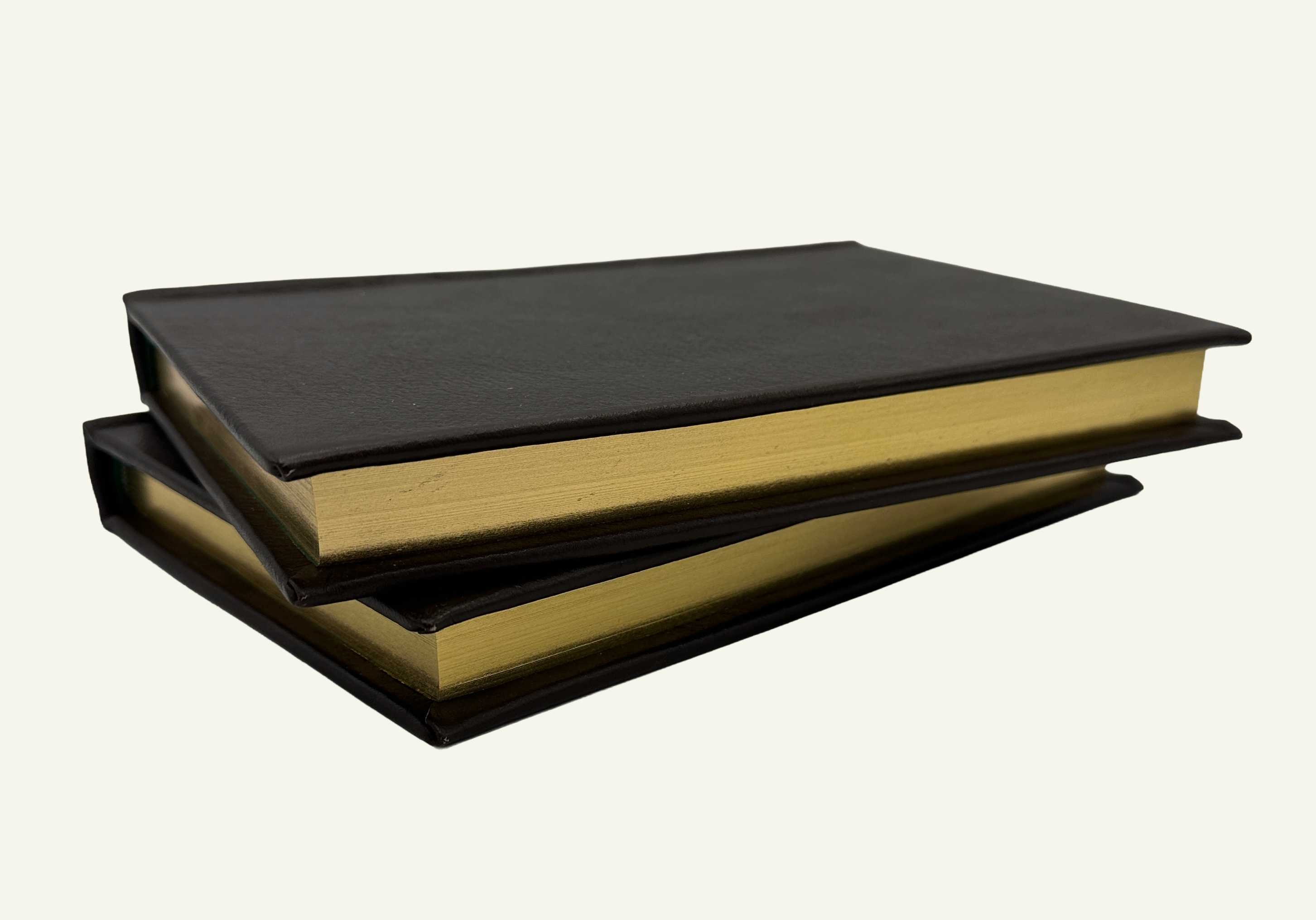 Close up of a handcrafted Italian leather notebook featuring gilded gold edges