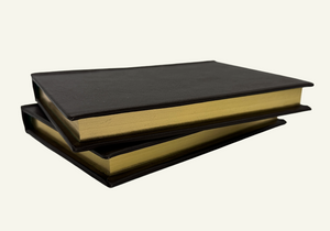 Close up of a handcrafted Italian leather notebook featuring gilded gold edges