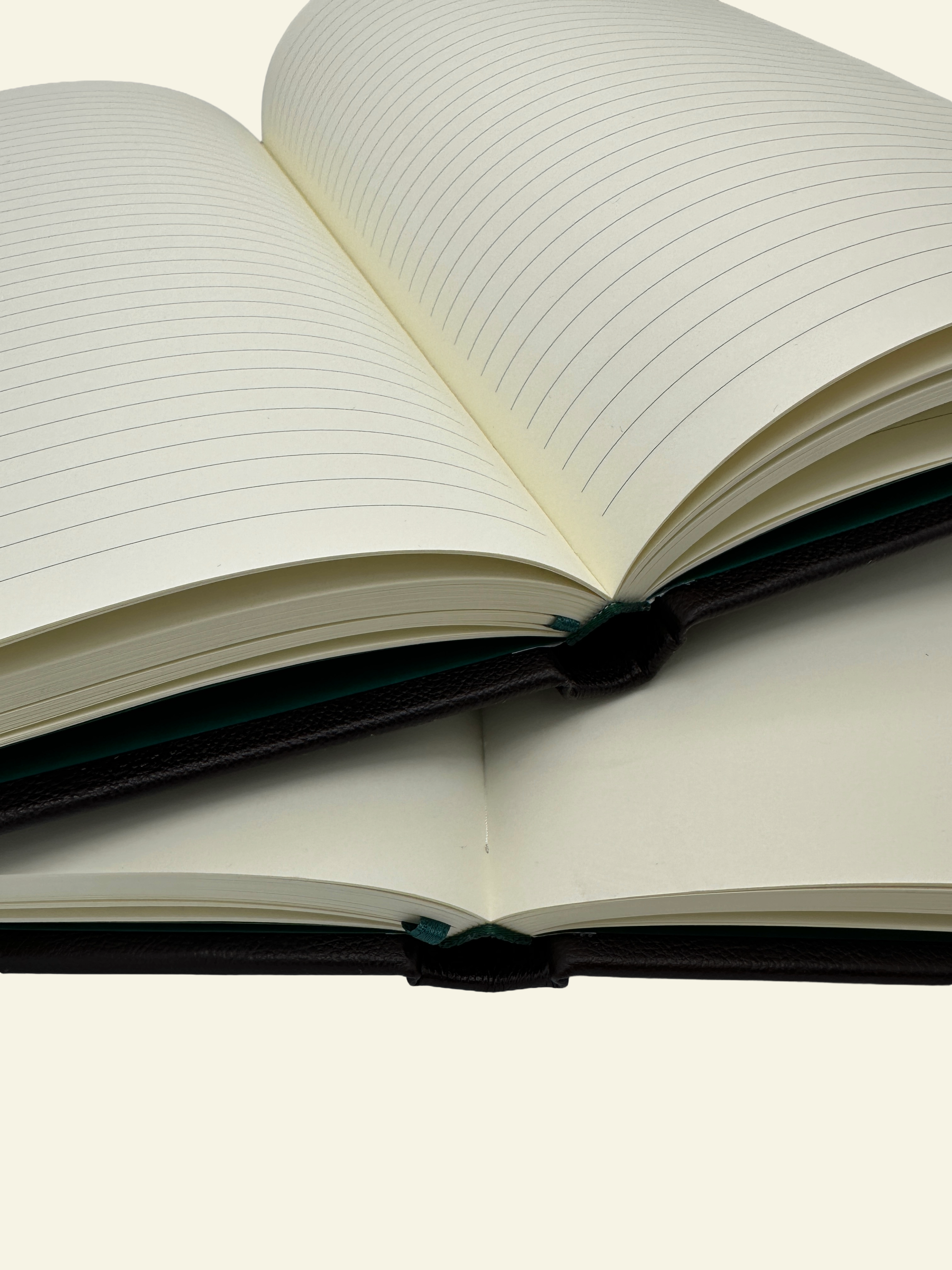 Open lined guestbook on top of an unlined guestbook