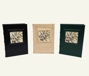 Black, distressed sand, and forest green leather journals featuring Italian olive branch artwork.