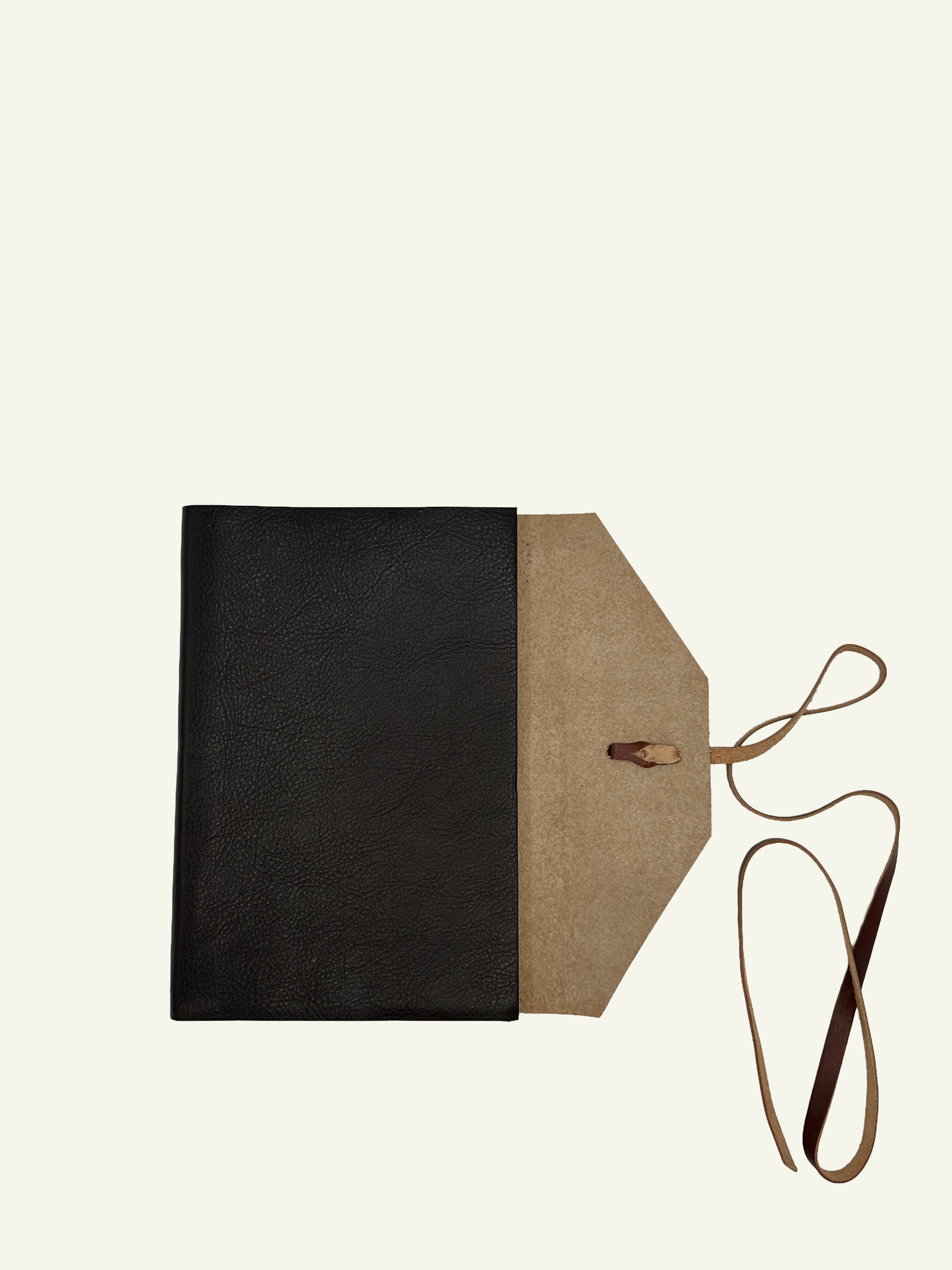 Handmade Italian leather wrap journal opened to show the soft suede interior and wrap-style closure.