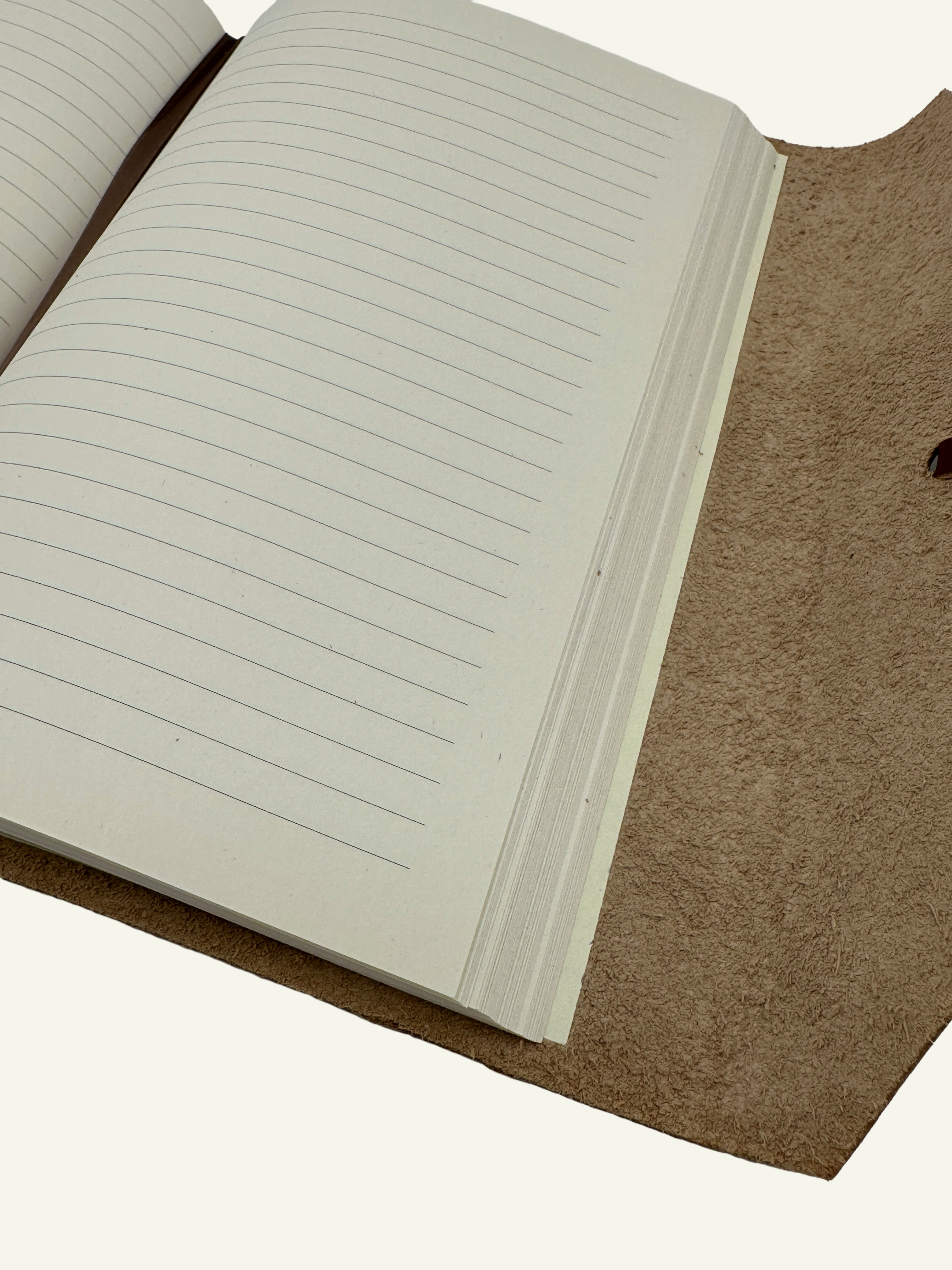 Close-up of lined archival-quality paper inside the handmade Italian leather wrap journal.