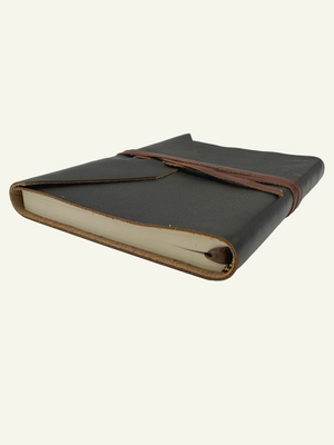 Side view of deep espresso Italian leather wrap journal showing thick lined pages and wrap closure.