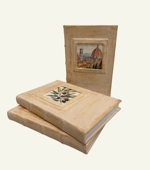 Three distressed sand leather journals featuring different Italian artwork in the portrait windows.