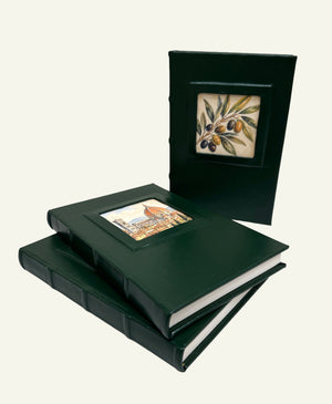 Three forest green leather journals featuring different Italian artwork in the portrait windows.