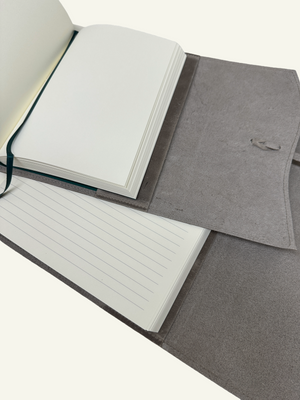 Open stone taupe leather journal showing blank and lined pages, leather cover, and interior construction.
