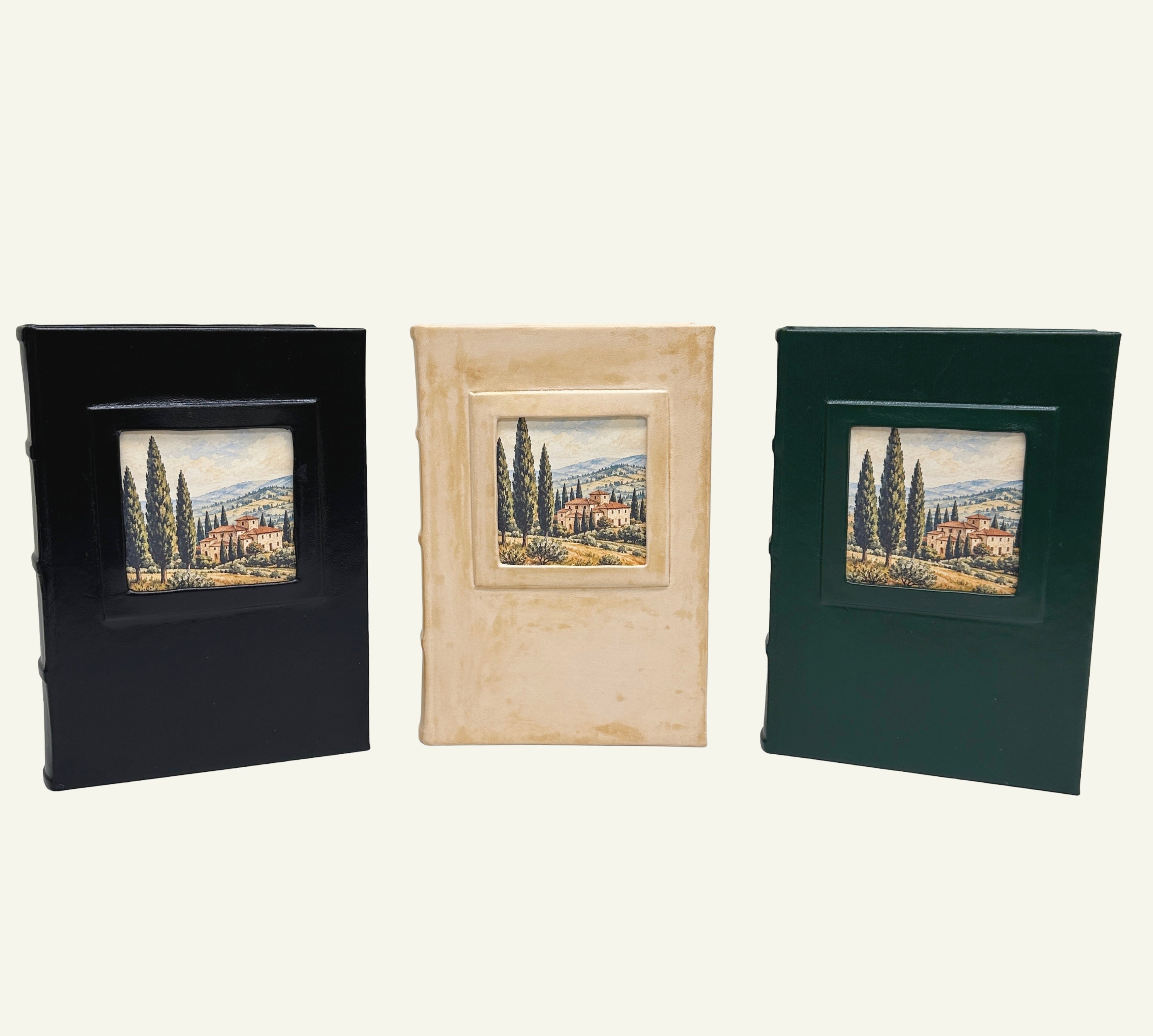 Black, distressed sand, and forest green leather journals featuring Tuscan village artwork.