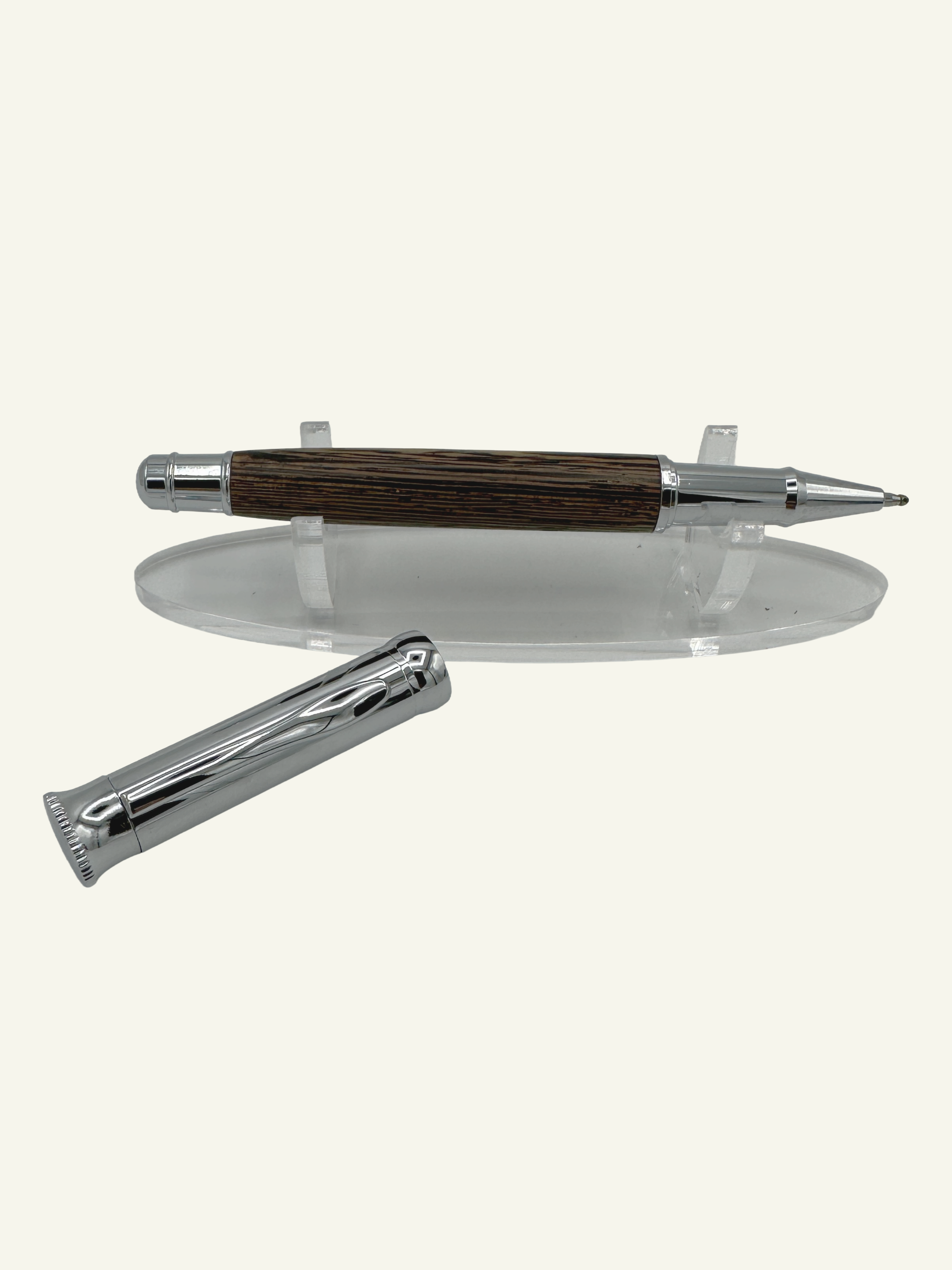 Wood barrel rollerball pen with removable chrome cap placed beside the pen to reveal the smooth-writing rollerball tip.