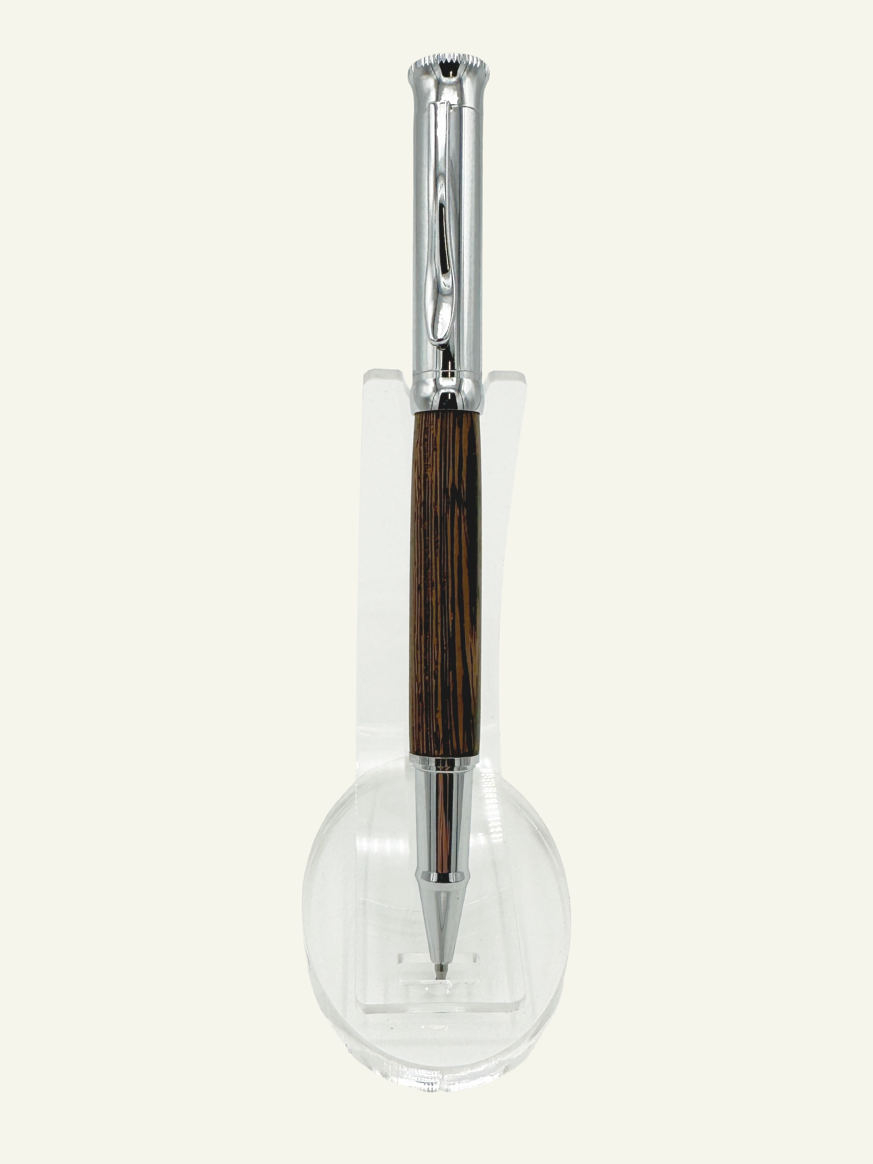 Close-up of the natural wood barrel showcasing the unique grain and polished chrome trim on an Italian rollerball pen.