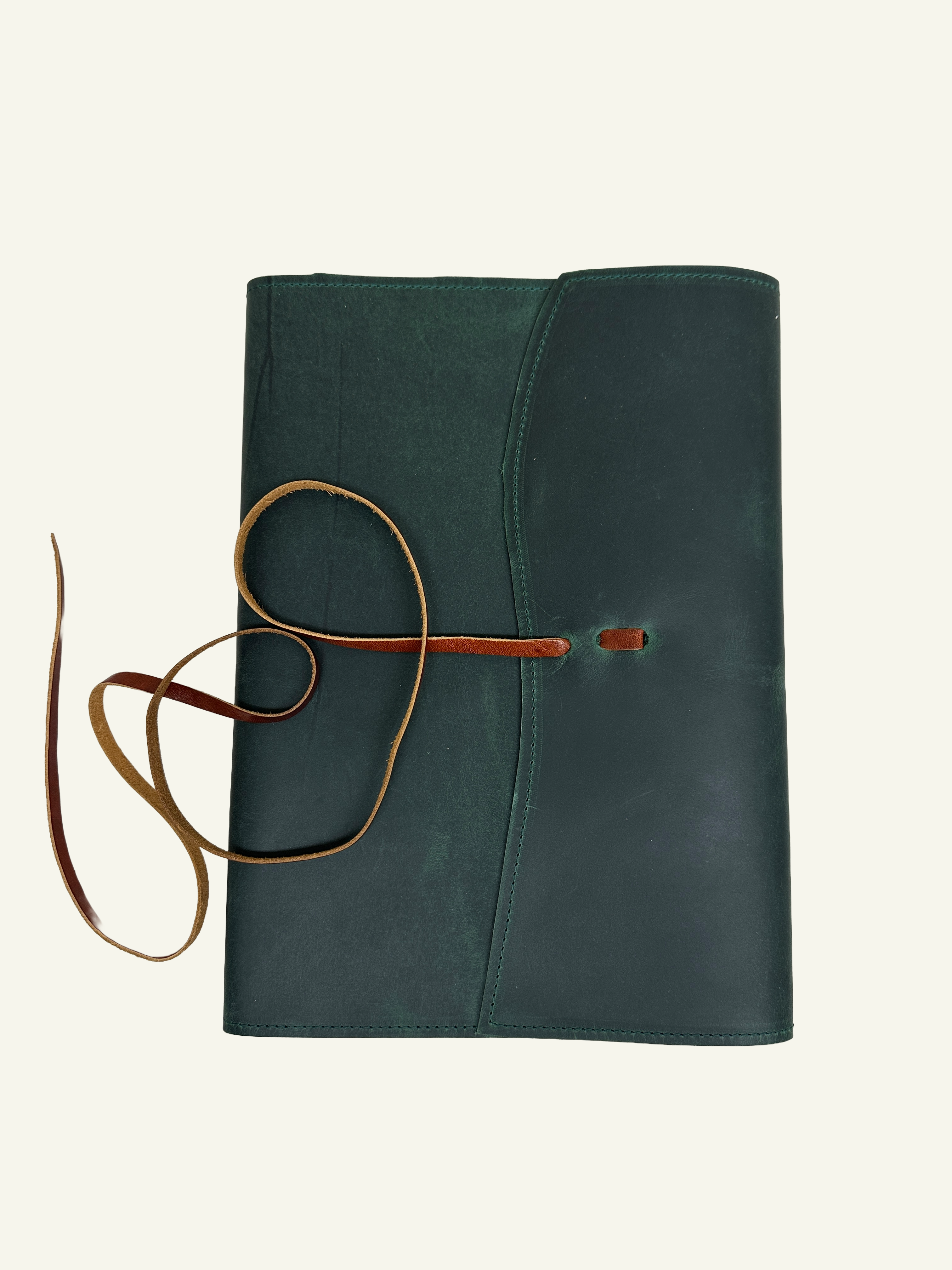 Open forest green refillable leather journal showing the wrap closure and interior