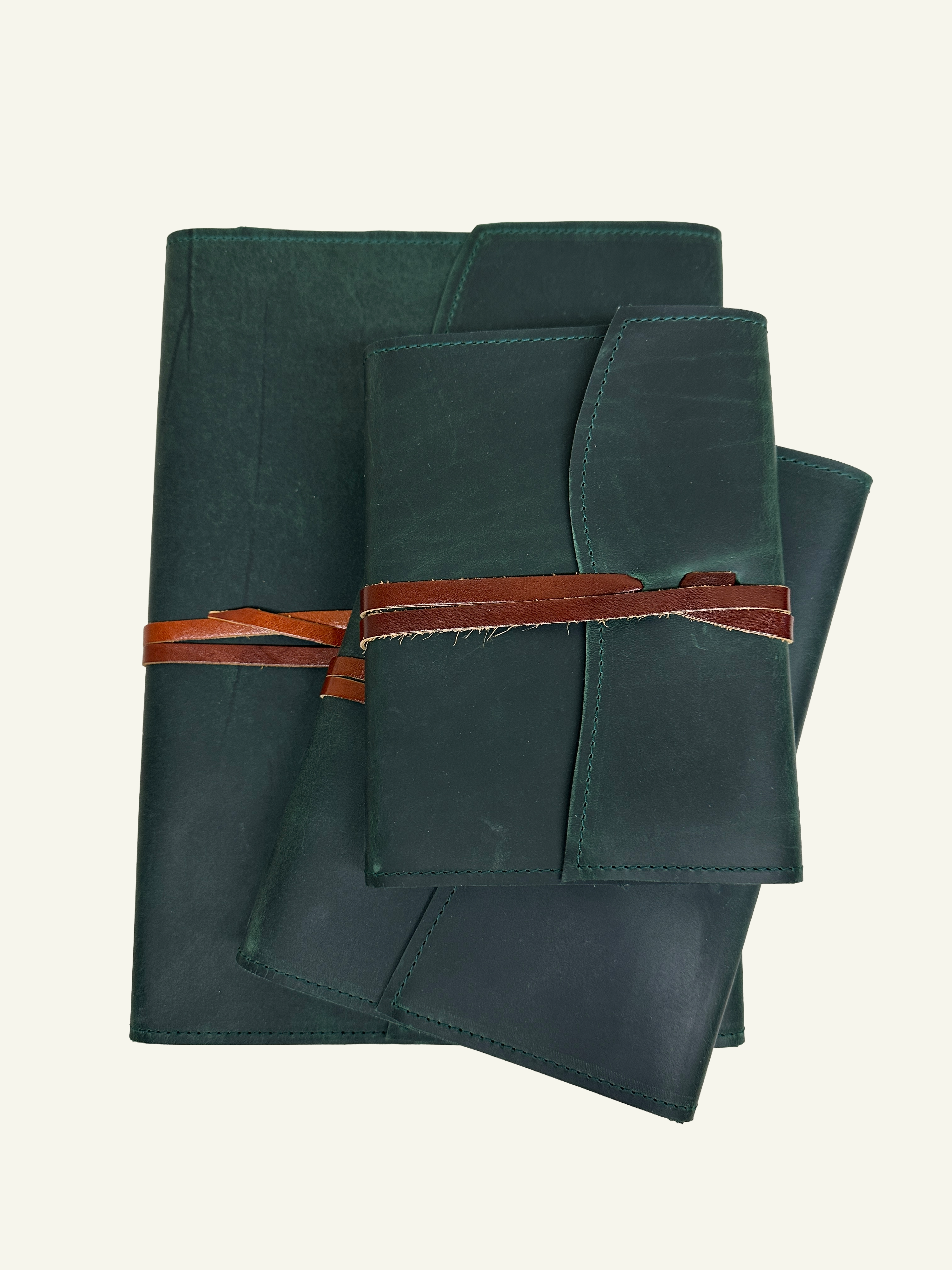 Forest green refillable leather wrap journals shown in three sizes