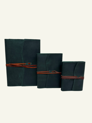 Three forest green softcover refillable leather journals in small, medium, and large sizes