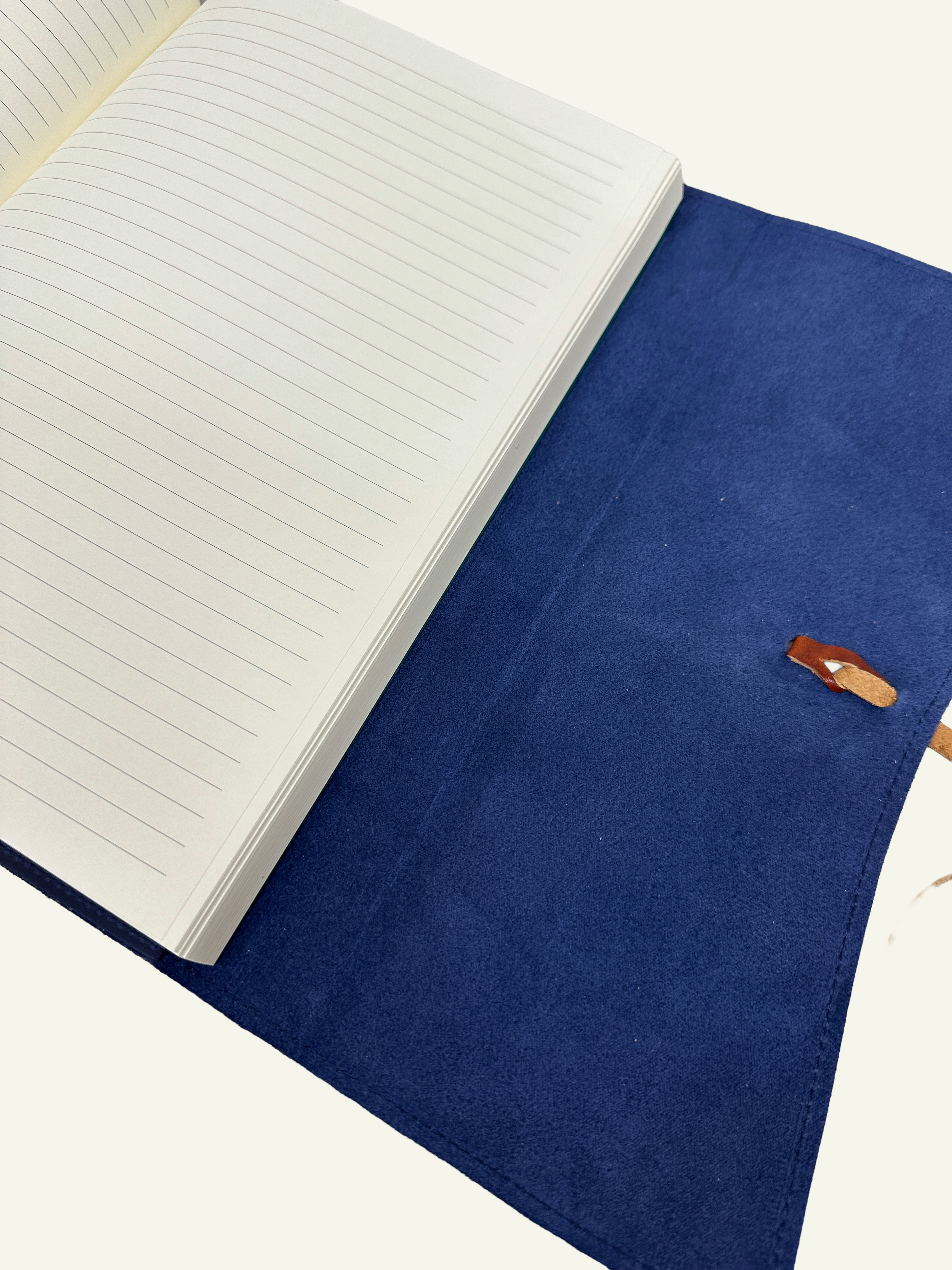 Open midnight blue refillable leather journal with lined paper insert