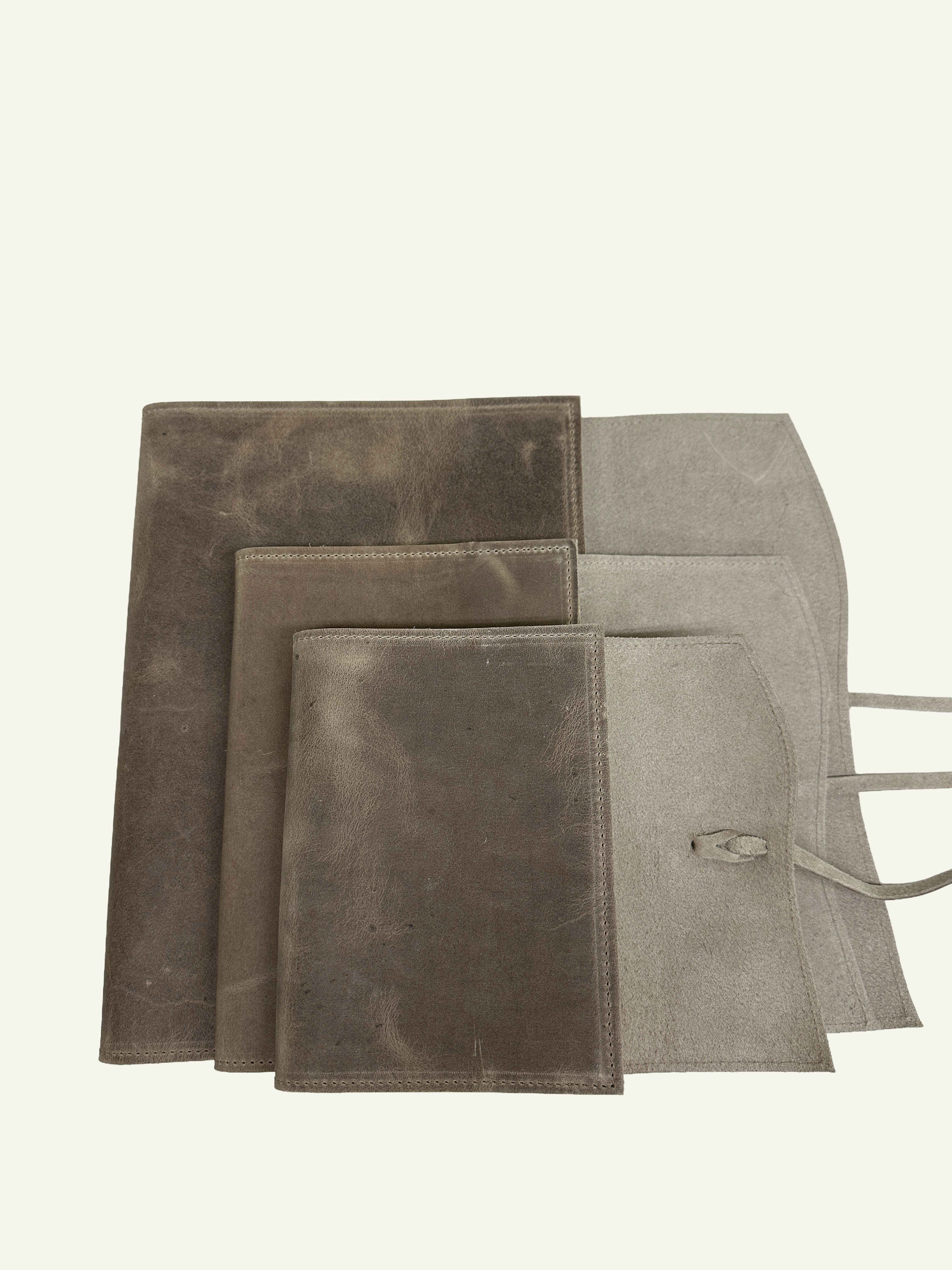 Stone taupe refillable leather journal covers shown in three sizes with natural suede-like interiors