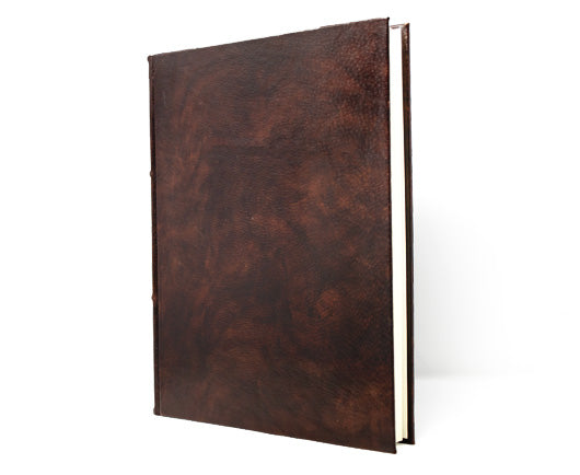 Vintage brown leather photo scrapbook albums on a grey wood